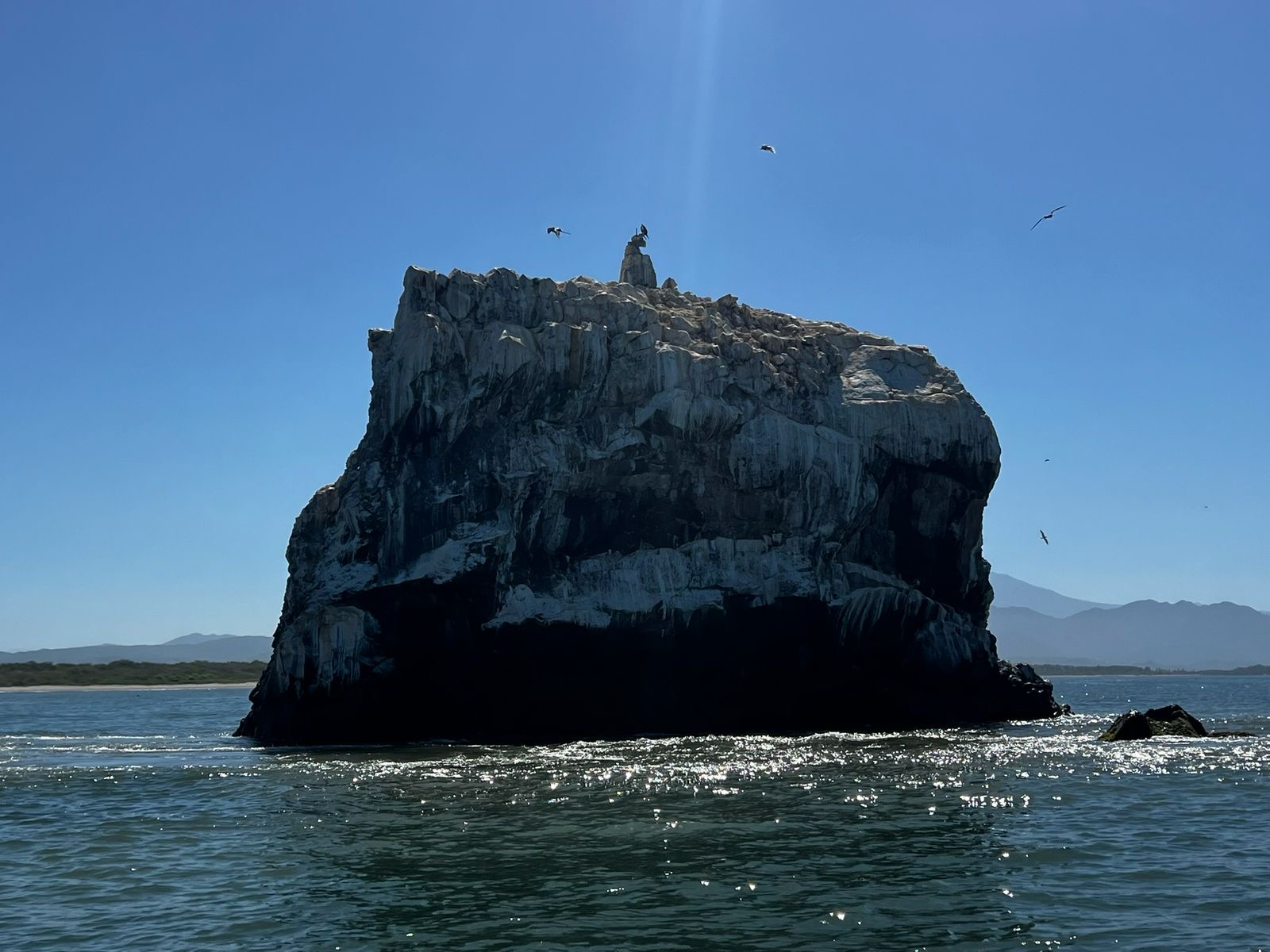 Tatéi Haramara rising from the Pacific under an open sky.